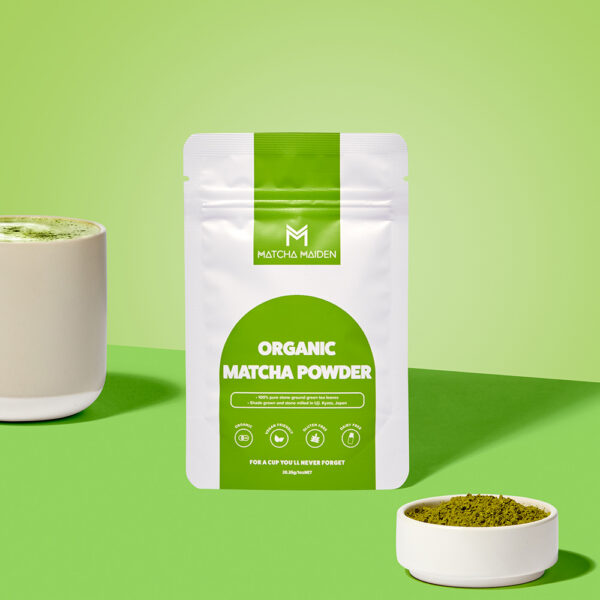 Matcha Maiden 28.35g organic matcha pouch with warm matcha latte and a bowl of green matcha powder.
